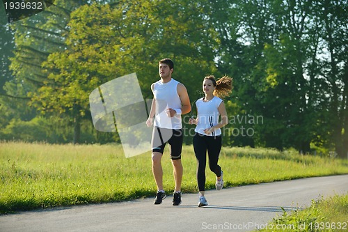 Image of Young couple jogging at morning