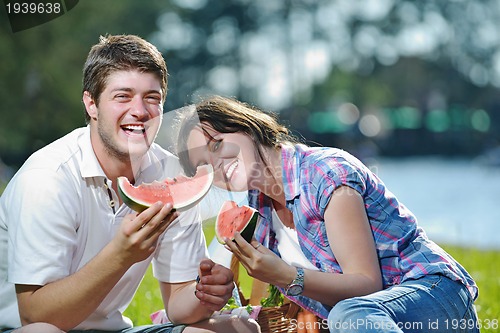 Image of happy young couple having a picnic outdoor