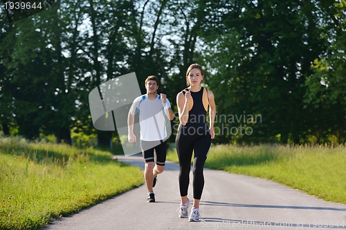 Image of Young couple jogging