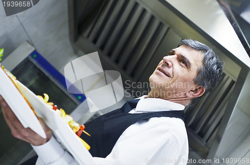 Image of male chef presenting food