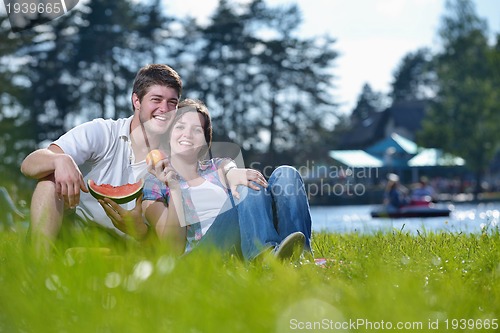 Image of happy young couple having a picnic outdoor