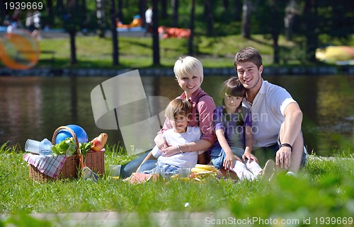 Image of Happy family playing together in a picnic outdoors