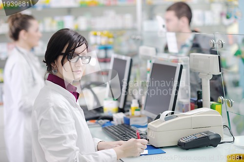 Image of pharmacist suggesting medical drug to buyer in pharmacy drugstor