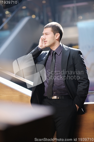 Image of young business man talking by cell phone