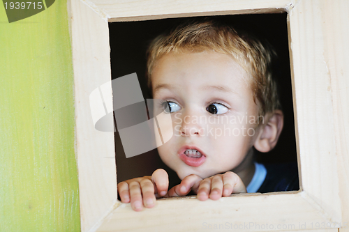 Image of happy child in a window