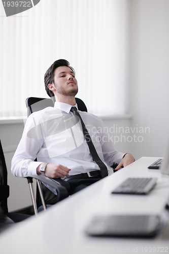 Image of tired and depresed young business man at office