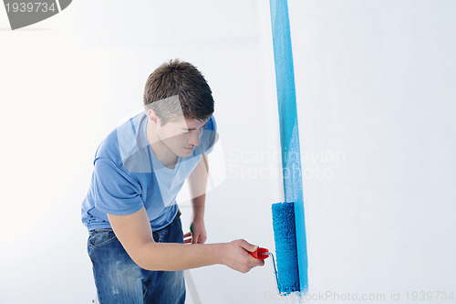 Image of happy couple paint wall at new home