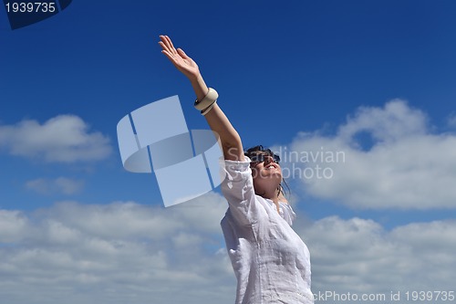 Image of happy young woman with spreading arms to sky