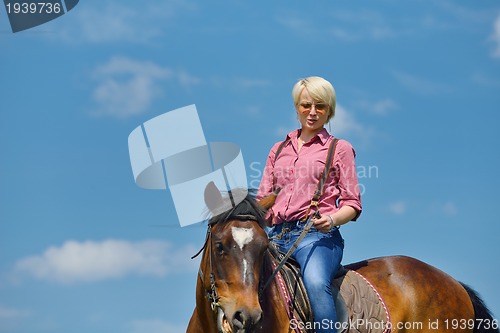 Image of happy woman  on  horse