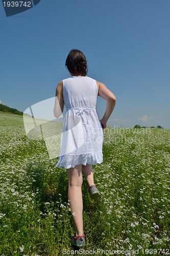 Image of Young happy woman in green field