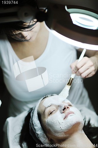 Image of woman with facial mask in cosmetic studio