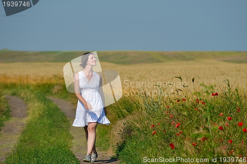 Image of Young happy woman in green field