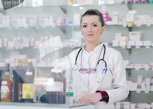 Image of pharmacist chemist woman standing in pharmacy drugstore