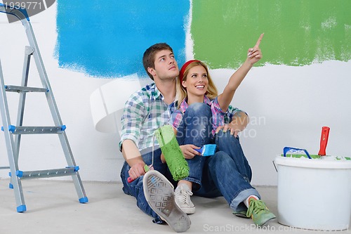 Image of happy young cople relaxing after painting in new home
