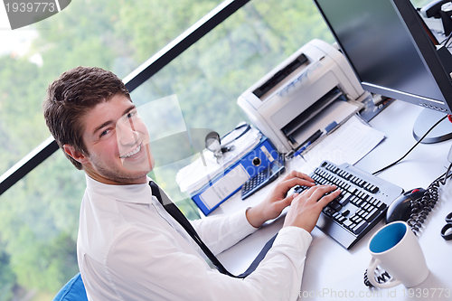 Image of happy young business man at office
