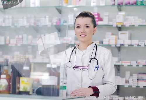 Image of pharmacist chemist woman standing in pharmacy drugstore