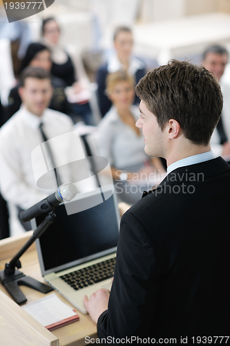 Image of Young  business man giving a presentation on conference
