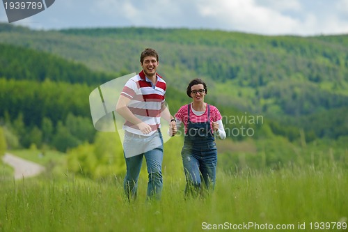 Image of Portrait of romantic young couple smiling together outdoor