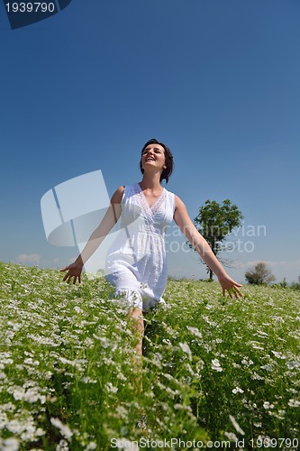 Image of Young happy woman in green field