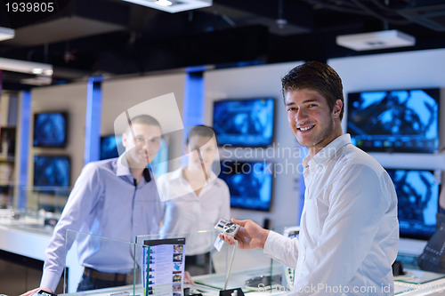 Image of Young couple in consumer electronics store