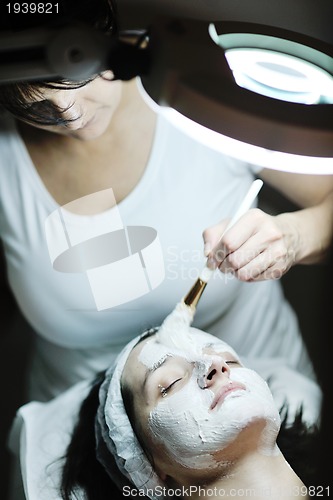 Image of woman with facial mask in cosmetic studio