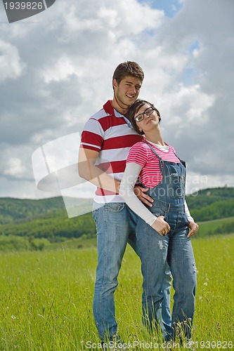 Image of Portrait of romantic young couple smiling together outdoor