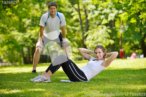 Image of Couple doing stretching exercise  after jogging