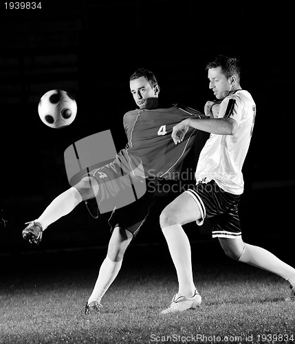 Image of football players in action for the ball