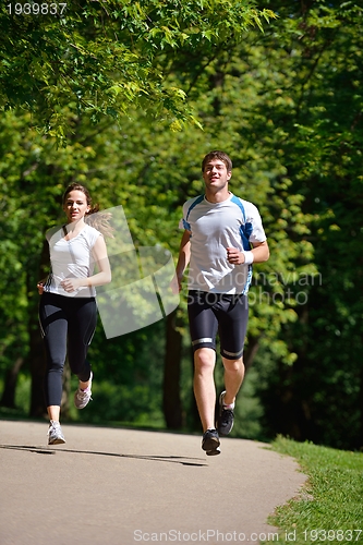 Image of Young couple jogging at morning