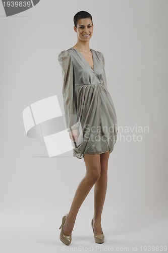 Image of elegant woman in fashionable dress posing in the studio