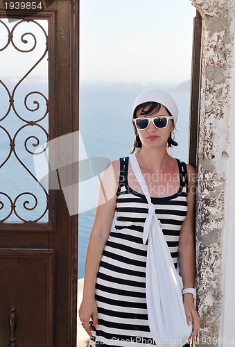 Image of Greek woman on the streets of Oia, Santorini, Greece