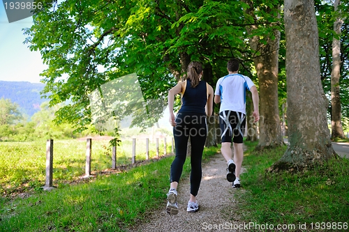 Image of Young couple jogging