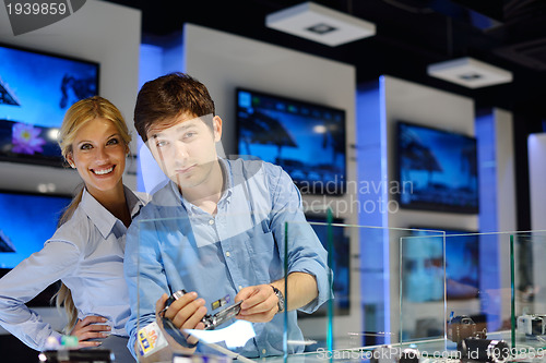 Image of Young couple in consumer electronics store