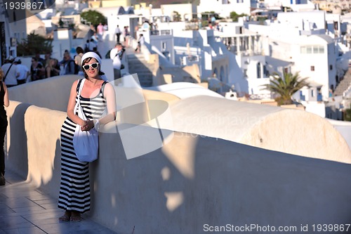 Image of Greek woman on the streets of Oia, Santorini, Greece