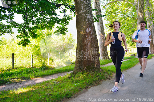 Image of Young couple jogging