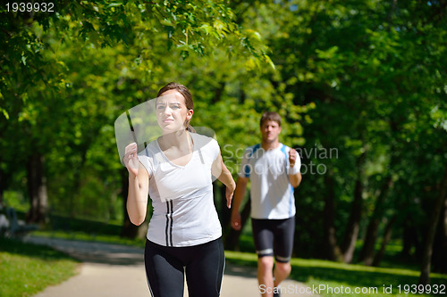 Image of Young couple jogging