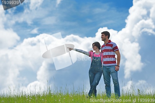 Image of Portrait of romantic young couple smiling together outdoor