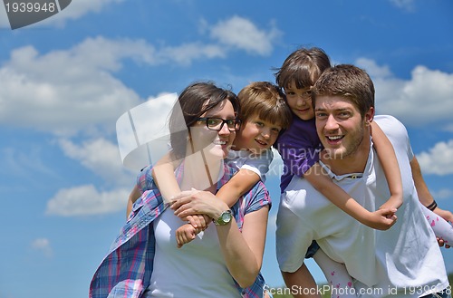 Image of happy young family have fun outdoors