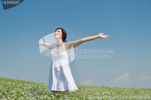Image of Young happy woman in green field