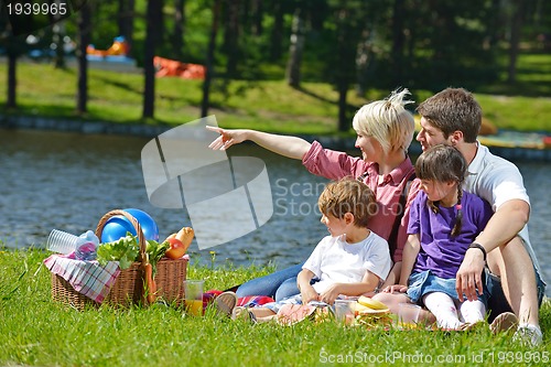 Image of Happy family playing together in a picnic outdoors