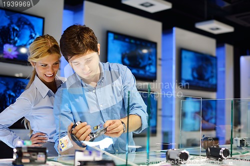 Image of Young couple in consumer electronics store