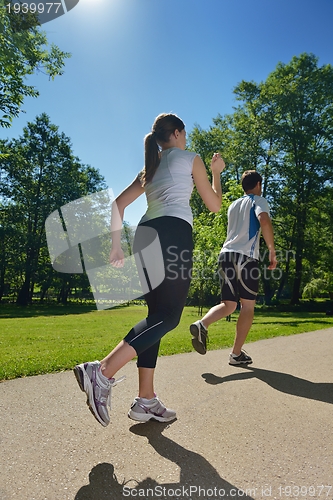 Image of Young couple jogging at morning