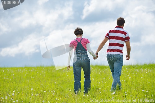 Image of Portrait of romantic young couple smiling together outdoor