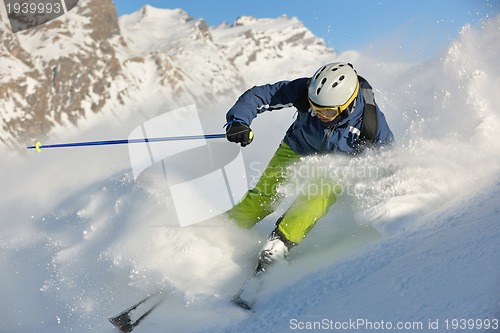Image of skiing on fresh snow at winter season at beautiful sunny day
