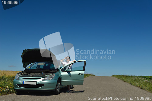 Image of woman with broken car