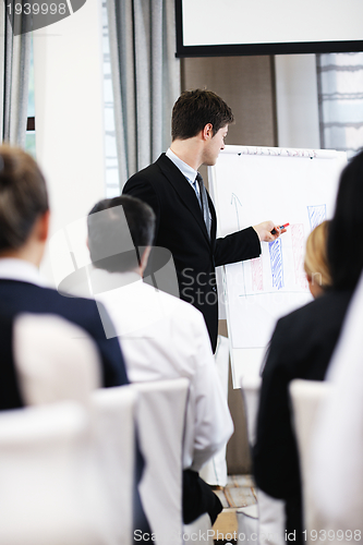 Image of Young  business man giving a presentation on conference