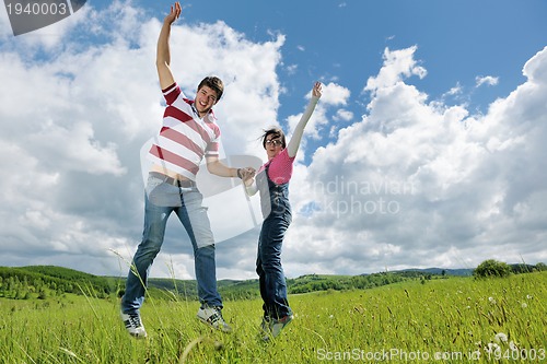 Image of Portrait of romantic young couple smiling together outdoor