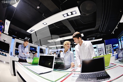 Image of Young couple in consumer electronics store