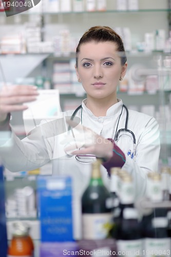 Image of pharmacist chemist woman standing in pharmacy drugstore