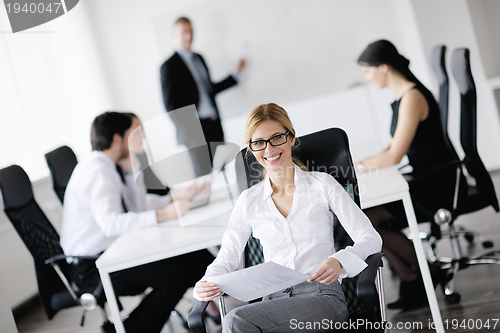 Image of business woman with her staff in background